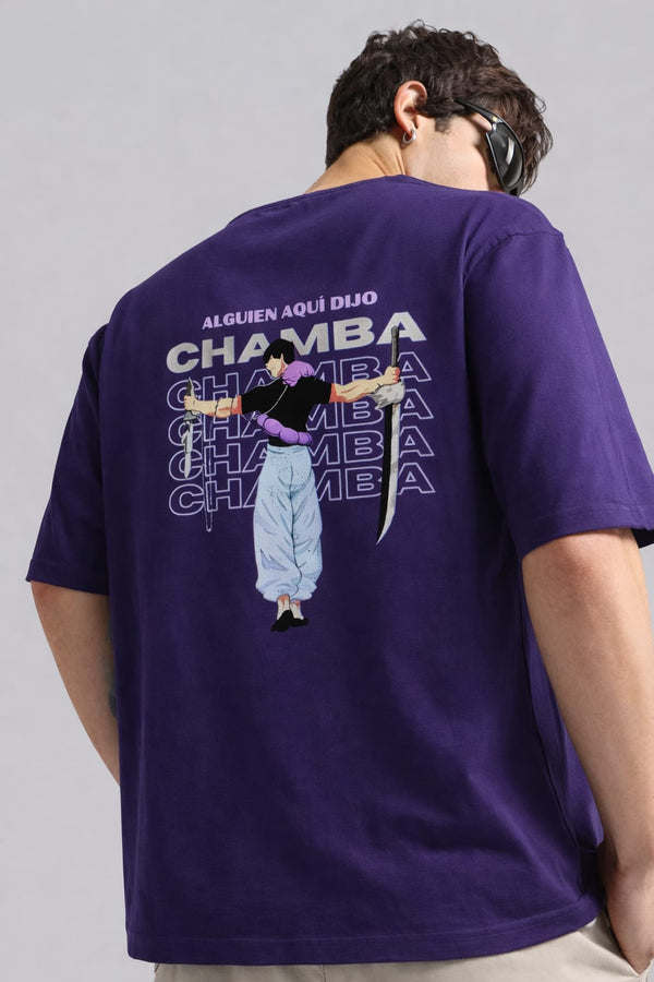 Person wearing a purple t-shirt with text and graphics on the back, standing against a gray background.
